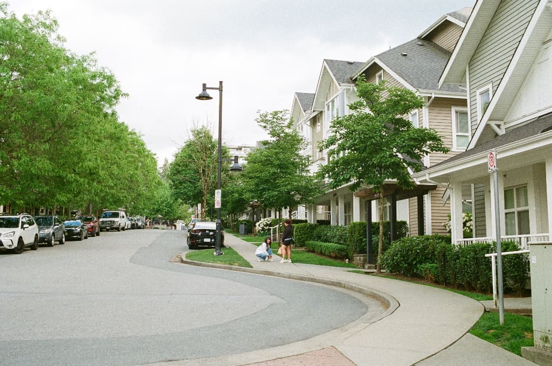 Townhomes along a tree-lined residential street in Metro Vancouver
